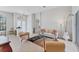 Inviting living room with neutral decor, tile flooring, and abundant natural light at 1311 Tuscany Blvd, Venice, FL 34292