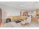 Open concept living room with views of kitchen, dining area, and outdoor space at 1311 Tuscany Blvd, Venice, FL 34292