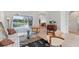 Open living room featuring neutral tones, stylish furniture, and seamless access to the outdoor lanai at 1311 Tuscany Blvd, Venice, FL 34292