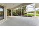 Large screened porch offers views of the lush landscaping, black mulch, and a serene pond at 1311 Tuscany Blvd, Venice, FL 34292