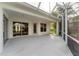 Spacious screened porch with views of lush landscaping and multiple entry points to the home at 1311 Tuscany Blvd, Venice, FL 34292