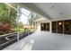 Large screened porch featuring lush landscaping and multiple entry points to the home at 1311 Tuscany Blvd, Venice, FL 34292