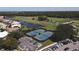 Aerial view of two tennis courts nestled near the golf course and residential area at 1311 Tuscany Blvd, Venice, FL 34292