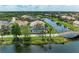 Aerial view showcasing community homes, lush landscaping, and waterfront views at 13167 Fernando St, Venice, FL 34293