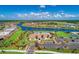 A beautiful aerial view of a community clubhouse and pool overlooking a scenic lake at 13167 Fernando St, Venice, FL 34293