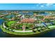 Gorgeous aerial view of the clubhouse, tennis courts, and lake in a well-maintained planned community at 13167 Fernando St, Venice, FL 34293