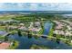 An aerial view shows a lakeside home with a screened-in pool within a Florida community at 13167 Fernando St, Venice, FL 34293