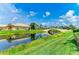 Picturesque backyard with lush landscaping and a scenic bridge over the water at 13167 Fernando St, Venice, FL 34293