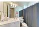 Bathroom featuring a single sink, toilet, flamingo decor, and a shower with a gray shower curtain at 13167 Fernando St, Venice, FL 34293