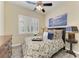 Comfortable bedroom featuring shuttered windows, modern furniture, and light wood-look flooring at 13167 Fernando St, Venice, FL 34293