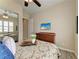 Bedroom featuring a tv, dresser, vase of flowers, wood-look floors and a mirror closet door at 13167 Fernando St, Venice, FL 34293