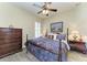 Bedroom featuring wood-look floors, a four-poster bed, matching nightstands, and a dresser at 13167 Fernando St, Venice, FL 34293