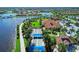 Aerial shot featuring the clubhouse, bocce ball courts, and a scenic pond in a Florida community at 13167 Fernando St, Venice, FL 34293