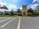 Stunning yellow clubhouse exterior featuring Spanish-style architecture, palm trees, and well-manicured landscaping at 13167 Fernando St, Venice, FL 34293
