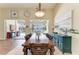 Dining area showcasing a large table, a chandelier, and views of the pool area at 13167 Fernando St, Venice, FL 34293