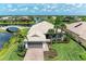 Stunning waterfront home featuring a tile roof, well-manicured lawn and mature palm trees at 13167 Fernando St, Venice, FL 34293