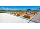 Community garden plots with multiple wooden raised beds in a landscaped area with blue awning and homes in the distance at 13167 Fernando St, Venice, FL 34293