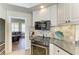 Close up of a modern kitchen with tile backsplash, granite counters and stainless appliances at 13167 Fernando St, Venice, FL 34293