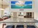 Gourmet kitchen featuring granite countertops, tile backsplash, and modern stainless steel appliances at 13167 Fernando St, Venice, FL 34293