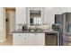 Open concept kitchen with white cabinets, stainless steel appliances, and granite countertops at 13167 Fernando St, Venice, FL 34293