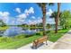 Relaxing lake view with palm trees and a bench along the walking path at 13167 Fernando St, Venice, FL 34293