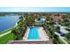 An aerial view of the lap pool and clubhouse in a beautifully landscaped community with lake views at 13167 Fernando St, Venice, FL 34293