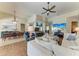 Open-concept living room showcasing a large sectional sofa, wood floors, and views of the kitchen at 13167 Fernando St, Venice, FL 34293