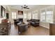 Cozy living room with a fireplace, hardwood floors, plantation shutters and leather furniture at 13167 Fernando St, Venice, FL 34293