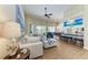 Spacious living room featuring a comfortable sectional sofa, wood floors, and an open layout at 13167 Fernando St, Venice, FL 34293