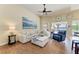 Inviting living room featuring a plush sectional sofa, wood floors, and sliding glass doors at 13167 Fernando St, Venice, FL 34293