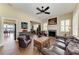Comfortable living room featuring a fireplace, hardwood floors, and a ceiling fan at 13167 Fernando St, Venice, FL 34293