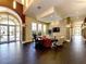 Elegant lobby area with dark wood floors, stone accent wall, comfortable seating, and a view to the outside at 13167 Fernando St, Venice, FL 34293
