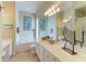 Bright main bathroom with dual sinks, soaking tub, vanity, and decorative ocean-themed decor at 13167 Fernando St, Venice, FL 34293