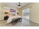 Comfortable bedroom featuring a ceiling fan, wood-look flooring, and sliding glass doors at 13167 Fernando St, Venice, FL 34293