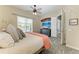 Cozy main bedroom featuring wood-look floors, ceiling fan, and view of a pool beyond the window at 13167 Fernando St, Venice, FL 34293