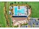 Aerial view shows a pool and clubhouse with well-manicured landscaping and plenty of space for relaxing at 13167 Fernando St, Venice, FL 34293