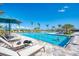 A full shot of the community pool with lounge chairs and people swimming at 13167 Fernando St, Venice, FL 34293