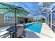 Outdoor seating and dining area with a pool and great lake view at 13167 Fernando St, Venice, FL 34293