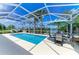 Inviting screened pool area with ample seating, overlooking a peaceful lake at 13167 Fernando St, Venice, FL 34293