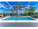 Sparkling swimming pool with a screened enclosure and serene lake views at 13167 Fernando St, Venice, FL 34293