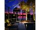 Relaxing screened-in pool area featuring a picturesque twilight view of the lake and a vibrant, colorful sky at dusk at 13167 Fernando St, Venice, FL 34293