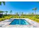 Community spa features a small, square pool surrounded by lush greenery and a black metal fence at 13167 Fernando St, Venice, FL 34293