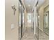 Long walk-in closet with mirrored doors leading to an ensuite bathroom with soaking tub at 13167 Fernando St, Venice, FL 34293