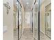 This walk-in closet offers mirrored doors and leads to the bathroom and other parts of the house at 13167 Fernando St, Venice, FL 34293