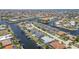 Aerial view of the community with numerous canals, waterfront homes, and tropical vegetation at 1424 Mediterranean Dr # 112, Punta Gorda, FL 33950