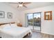 Bedroom with sliding glass doors leading to a balcony and wood laminate flooring at 1424 Mediterranean Dr # 112, Punta Gorda, FL 33950