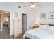 Bright bedroom with wood frame bed, white bedding and light colored dresser at 1424 Mediterranean Dr # 112, Punta Gorda, FL 33950
