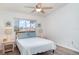 Cozy bedroom with a ceiling fan, wood-look floors, and serene decor at 1424 Mediterranean Dr # 112, Punta Gorda, FL 33950