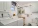 Laundry room with washer, dryer, storage, mirror, and toilet at 1424 Mediterranean Dr # 112, Punta Gorda, FL 33950