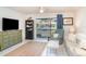 Bright living room features tile flooring, neutral furniture, and sliding doors to a screened lanai at 1424 Mediterranean Dr # 112, Punta Gorda, FL 33950